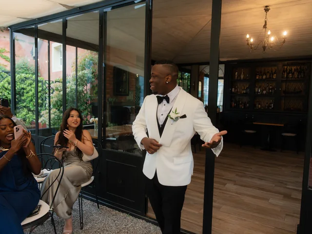 Groom in a white dinner jacket dancing with guests