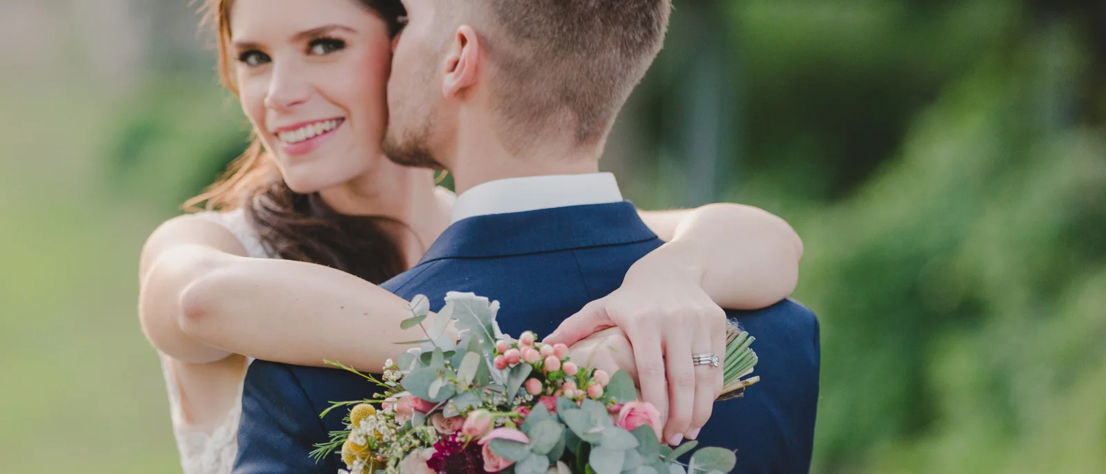 Bride and groom holding a Lillipollen bridal bouquet