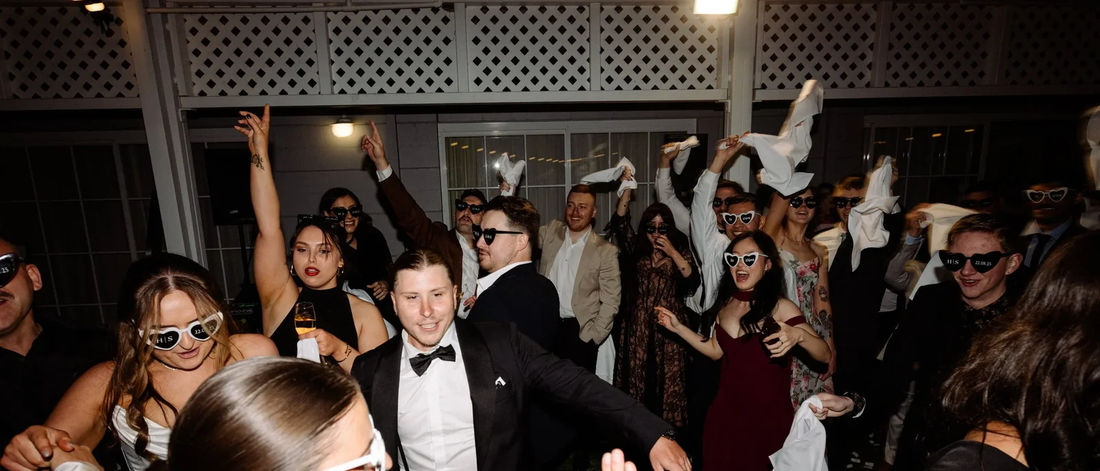 Guests on a packed wedding dance floor