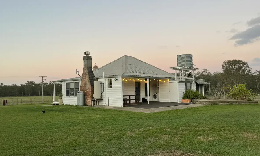 The four-bedroom heritage farmhouse at Adeline Estate, seen across the paddock