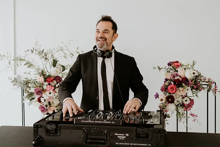 Melbourne Entertainment Company: DJ set up between floral arrangements