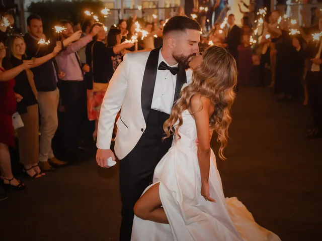 ATEIA Photography & Video: Newlyweds kiss beneath a guard of honour of sparklers