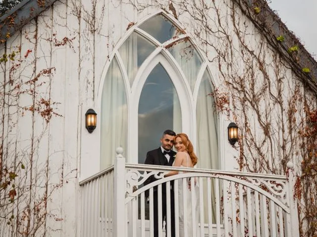 ATEIA Photography & Video: Newlyweds on the porch of a white wedding chapel