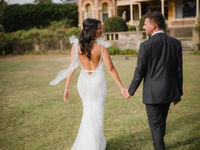 ATEIA Photography & Video: Couple walk hand in hand across the lawn of a heritage mansion