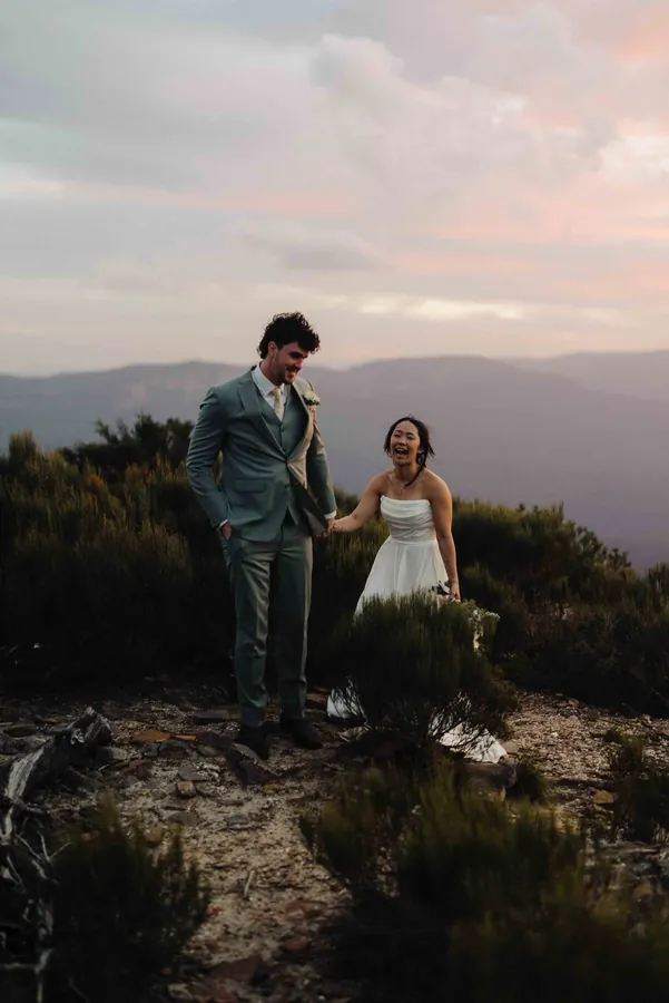 Fable Weddings: Couple on a clifftop at dusk in the mountains