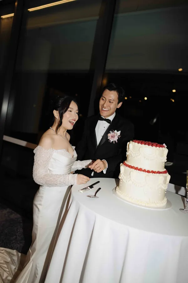 Fable Weddings: Couple laughing as they cut their wedding cake