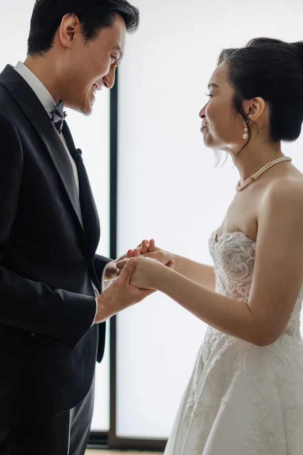 Fable Weddings: Groom sliding the ring onto his bride's finger