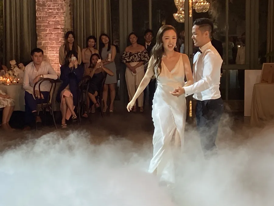 Wedding DJ Hire: couple sharing their first dance through low fog