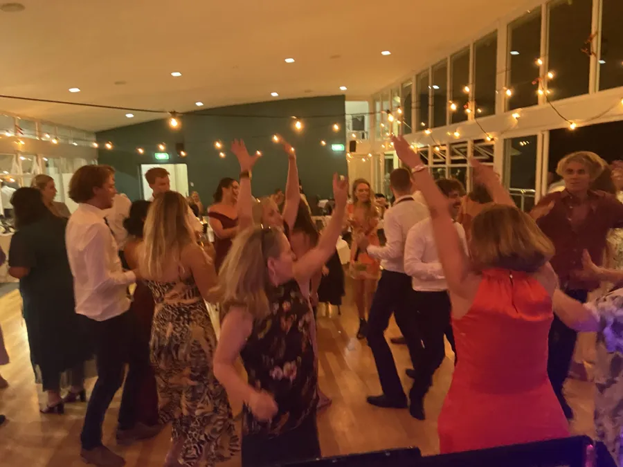 Wedding DJ Hire: guests dancing under festoon lights