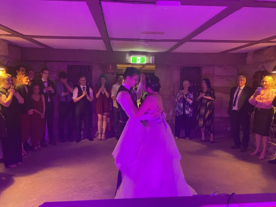 Wedding DJ Hire: couple dancing while guests look on