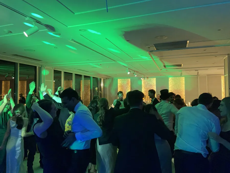 Wedding DJ Hire: guests dancing under green lights