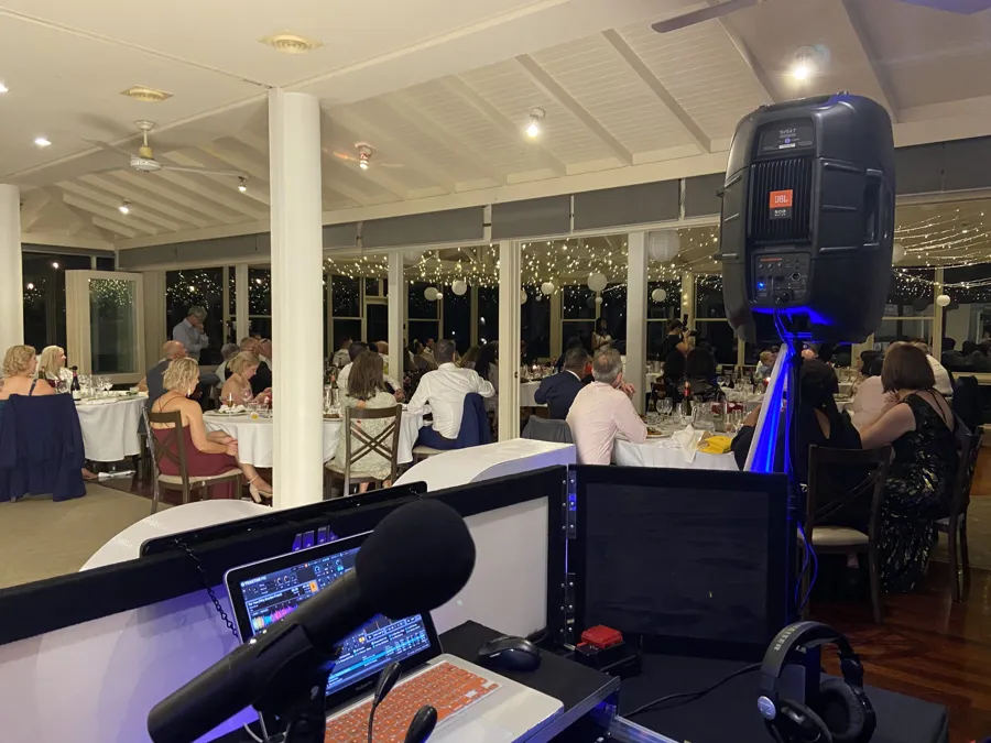 Wedding DJ Hire: the DJ booth set up beside the reception tables