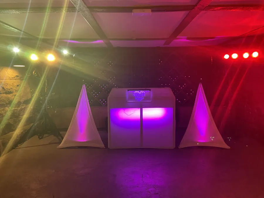 Wedding DJ Hire: DJ booth with red and purple party lighting