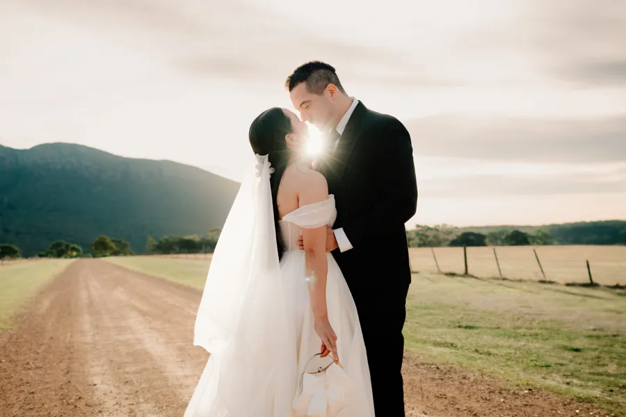 Meredith Photography: couple sharing a kiss on a country road at sunset