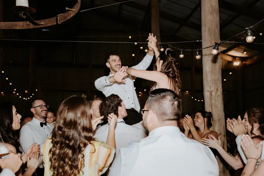 Meredith Photography: couple lifted up on the dance floor at The Hayshed