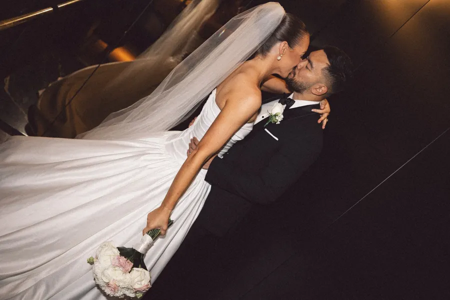 Rogue Weddings: the couple kissing as the veil drifts