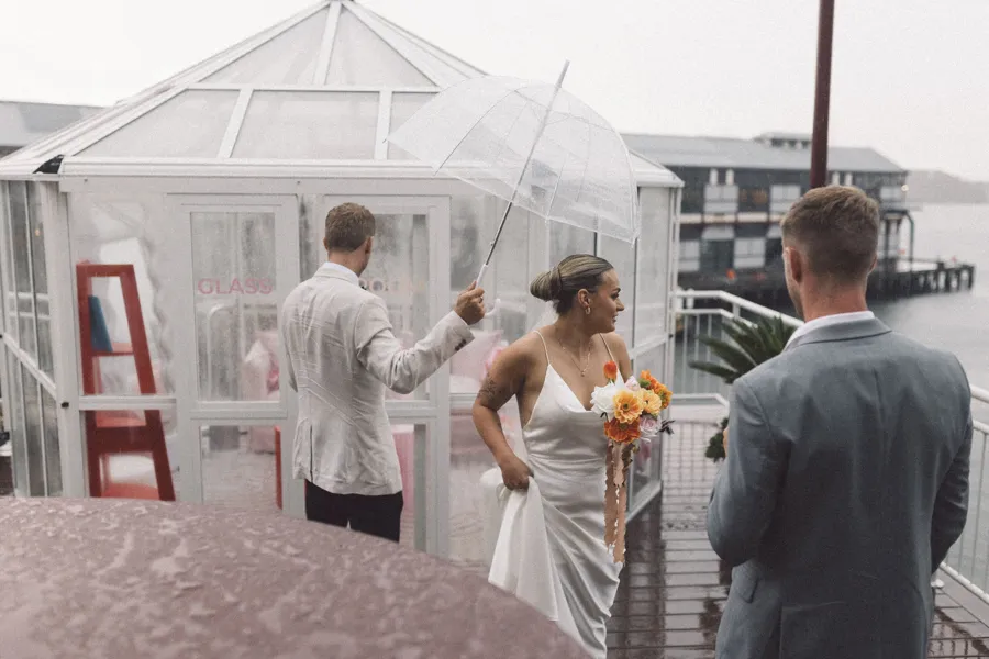 Rogue Weddings: a rainy waterfront ceremony beside a glasshouse