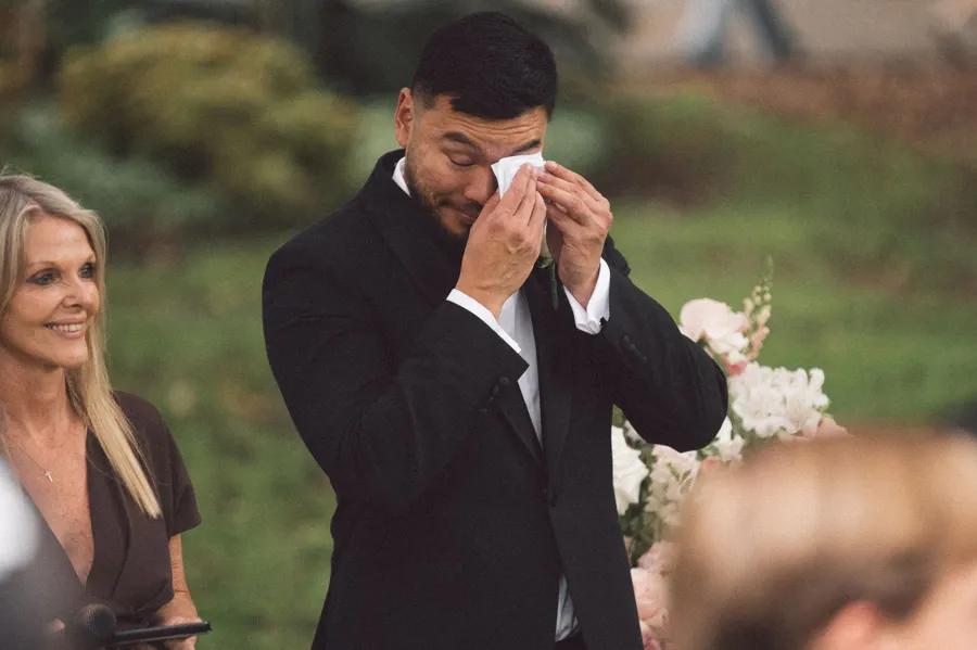 Rogue Weddings: the groom wiping away tears during the ceremony