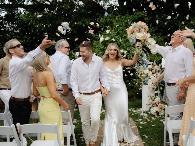 Lovesick Weddings: Guests throw petals as the couple walk back down the aisle