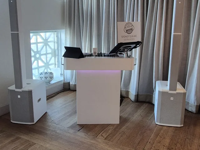 Sydney DJ & MC Services: White DJ booth and column speakers set up at a wedding venue