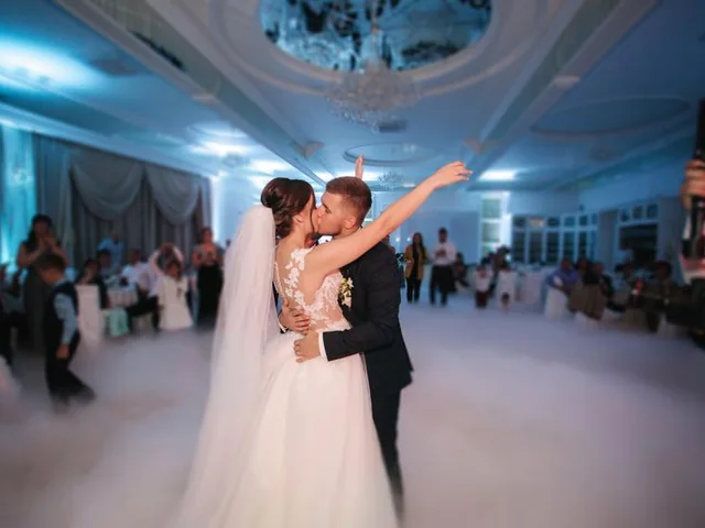 Sydney DJ & MC Services: Newlyweds kiss during their first dance on a fog-covered dance floor