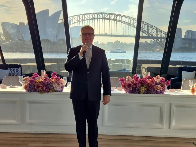Sydney DJ & MC Services: Richard as MC at a harbourside reception with the Opera House and Harbour Bridge behind