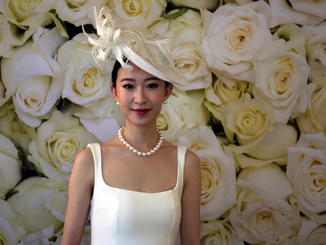 Sydney DJ & MC Services: Guest in a white fascinator and pearls at the photo booth