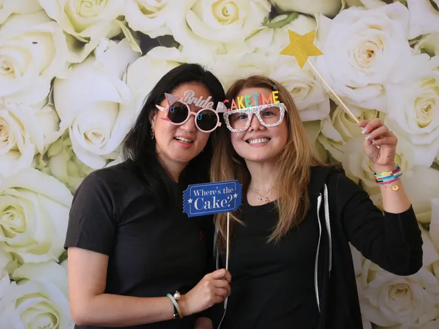 Sydney DJ & MC Services: Two guests with Bride and Cake Time glasses and a Where is the Cake sign