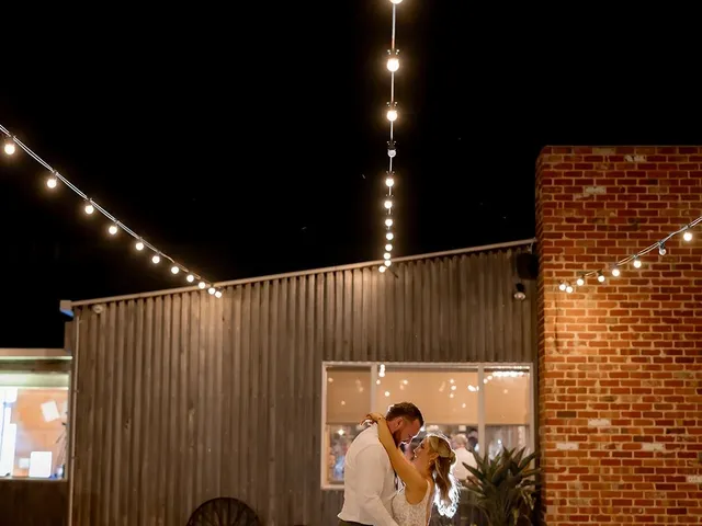 The Shearing Shed: Couple dancing under festoon lights in The Courtyard at night